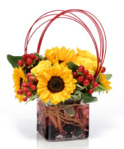 sunflowers and red berrries in cube