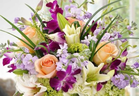 Purple dendrobium orchids are set in contrast with peach roses and green hydrangea. Just bursting with life and, as the title suggests, “For Love!” This arrangement will warm the heart of its lucky recipient.