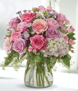 lovely arrangement of hydrangea and roses in a compact design
