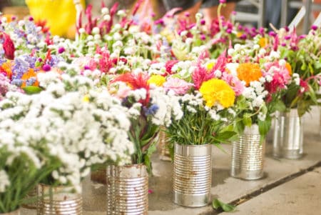 Bright and colorful flowers in tin cans