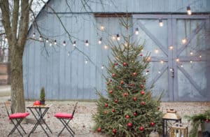 Christmas outdoor terrace with table, chairs, Christmas tree and Christmas decorations and lights